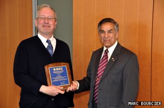 ENCS Associate Dean, Academic Affairs, Christopher Trueman (left) accepts the 2009 Supporting Friend of the IEEE Member and Geographic Activities Award on behalf of the Faculty from IEEE Canada President-elect Om Malik (right).
